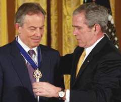 Receiving a medal from cohort Bush